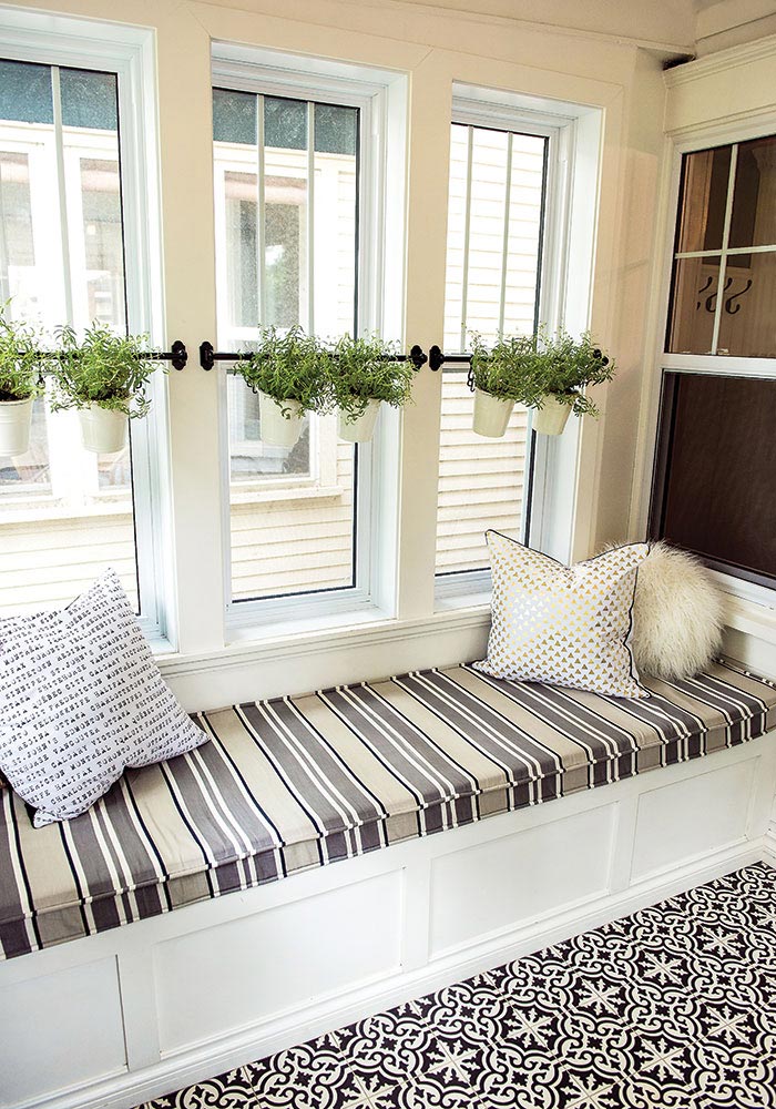 White storage bench upholstered in a french ticking pattern