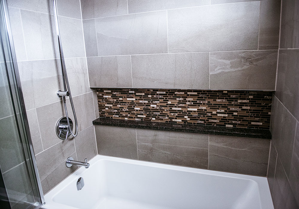 Brown Bathroom with Tiled Bath and Sower combo